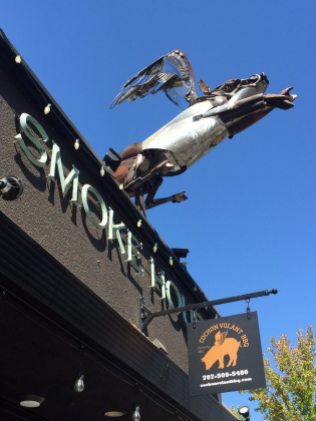 Cochon Volant metal sculpture atop restaurant. BBQ Smoke House just steps away from our wine country guesthouse The Big and Juicy Grape.